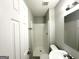 This tidy bathroom features a stall shower, toilet, and vanity with an unframed mirror at 3170 W Point Cir, Douglasville, GA 30135