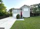 Charming home with gray siding, a red front door, a driveway, and a fenced yard at 3170 W Point Cir, Douglasville, GA 30135