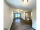Open-concept living room featuring vinyl floors, natural light, and neutral paint at 3170 W Point Cir, Douglasville, GA 30135