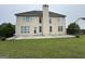 Exterior backyard view of the house featuring a deck and spacious green lawn at 1031 Jordan Rd, Dacula, GA 30019