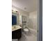 Bathroom featuring a vanity with black cabinets, toilet and a shower over tub combo at 1031 Jordan Rd, Dacula, GA 30019