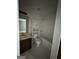 Bathroom with white tile, and vanity with dark cabinetry at 1031 Jordan Rd, Dacula, GA 30019