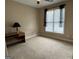 Neutral bedroom with a ceiling fan, large window, and a desk area, ready for personalization at 1031 Jordan Rd, Dacula, GA 30019