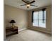 Neutral bedroom with a ceiling fan, large window, and a desk area, ready for personalization at 1031 Jordan Rd, Dacula, GA 30019