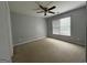 Carpeted bedroom featuring natural light and a ceiling fan at 1031 Jordan Rd, Dacula, GA 30019