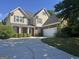 Charming two-story home with brick accents, manicured landscaping, and a spacious driveway at 1031 Jordan Rd, Dacula, GA 30019