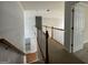 Upstairs hallway with view of the staircase and a bedroom door at 1031 Jordan Rd, Dacula, GA 30019