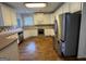 Spacious kitchen featuring stainless steel appliances, wooden floors, and white cabinets at 1031 Jordan Rd, Dacula, GA 30019