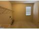 Laundry room with window, tile floor, wire rack, and hookups at 1031 Jordan Rd, Dacula, GA 30019