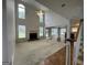 Open living room with fireplace, vaulted ceiling and natural light from multiple windows at 1031 Jordan Rd, Dacula, GA 30019