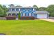 Charming two-story blue home featuring a well-manicured lawn and a two-car garage at 108 Country Acres Ct, Mcdonough, GA 30253