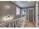 Upstairs hallway featuring neutral walls, carpet, and bright overhead lighting at 108 Country Acres Ct, Mcdonough, GA 30253