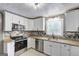 Updated kitchen featuring granite countertops, tile backsplash, and stainless steel appliances at 108 Country Acres Ct, Mcdonough, GA 30253