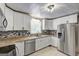 Bright kitchen featuring stainless steel appliances, granite countertops, and tile flooring at 108 Country Acres Ct, Mcdonough, GA 30253