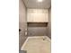 Empty laundry room space with overhead cabinets and tile flooring at 108 Country Acres Ct, Mcdonough, GA 30253