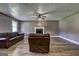 Spacious living room with wood-look flooring, a ceiling fan and a traditional fireplace at 108 Country Acres Ct, Mcdonough, GA 30253