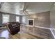 Relaxing living room with leather furniture, wood-look flooring, and a cozy fireplace at 108 Country Acres Ct, Mcdonough, GA 30253