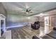 Living room featuring wood floors, a white fireplace, and an open design to the dining area at 108 Country Acres Ct, Mcdonough, GA 30253
