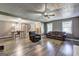 Open living space featuring hardwood floors, two windows, a ceiling fan, and grey walls at 108 Country Acres Ct, Mcdonough, GA 30253
