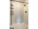 Modern shower featuring decorative tile, a bronze rainfall showerhead, and a shelving unit at 108 Country Acres Ct, Mcdonough, GA 30253