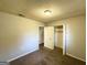 Bedroom features neutral walls, carpet, and an open closet for convenient storage at 4039 Codel Nw St, Atlanta, GA 30331