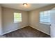 Cozy bedroom featuring two bright windows, plush carpeting, and neutral paint tones at 4039 Codel Nw St, Atlanta, GA 30331