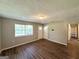 Inviting living room with wood-look floors, neutral walls and natural light from a window at 4039 Codel Nw St, Atlanta, GA 30331