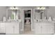 Bright bathroom with double vanities, mirrors and an open doorway to a walk-in closet at 1104 Victoria Ne St, Atlanta, GA 30319