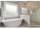 Elegant bathroom showcasing a soaking tub with modern fixtures and a glass-enclosed shower at 1104 Victoria Ne St, Atlanta, GA 30319