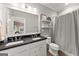 Bathroom with double sinks, large mirror, shower curtain, and decor shelves for a modern touch at 1104 Victoria Ne St, Atlanta, GA 30319