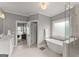 Bright bathroom featuring a soaking tub, glass-enclosed shower, and white vanities with ample counter space at 1104 Victoria Ne St, Atlanta, GA 30319