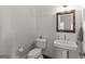 Elegant half-bathroom with white fixtures, a pedestal sink, and tasteful decor at 1104 Victoria Ne St, Atlanta, GA 30319