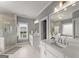 Modern bathroom featuring double vanities, a glass-enclosed shower, and a soaking tub for relaxation at 1104 Victoria Ne St, Atlanta, GA 30319