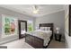 Bedroom with windows, a queen bed, and a full-length mirror, providing ample space and natural light at 1104 Victoria Ne St, Atlanta, GA 30319