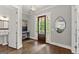 Elegant foyer with dark wood floors, stylish mirror, and a view to the covered front porch at 1104 Victoria Ne St, Atlanta, GA 30319