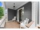 Charming front porch with seating, brick flooring, and a stylish exterior featuring gray siding at 1104 Victoria Ne St, Atlanta, GA 30319