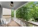 Inviting front porch with brick flooring, rocking chair, and white railings offering a relaxing outdoor space at 1104 Victoria Ne St, Atlanta, GA 30319