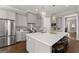Elegant kitchen featuring stainless steel appliances, granite countertops, an island, and pendant lighting at 1104 Victoria Ne St, Atlanta, GA 30319