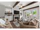 Cozy living room with fireplace, wood beams, comfortable seating, and French doors to the deck at 1104 Victoria Ne St, Atlanta, GA 30319