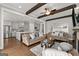 Open concept living room showcasing beamed ceilings, hardwood floors and a seamless flow into the kitchen and dining area at 1104 Victoria Ne St, Atlanta, GA 30319