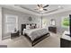 Spacious main bedroom featuring a tray ceiling, ceiling fan, and several windows for ample natural light at 1104 Victoria Ne St, Atlanta, GA 30319