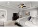 Inviting bedroom featuring a tray ceiling, ceiling fan, large television, and calming wall art at 1104 Victoria Ne St, Atlanta, GA 30319