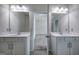Bright bathroom featuring double vanities, sleek mirrors, and a doorway leading to the bedroom at 158 Bryon Ln, Acworth, GA 30102