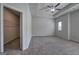 Spacious bedroom with ceiling fan, neutral carpet, and a closet with wire shelving visible through open door at 158 Bryon Ln, Acworth, GA 30102