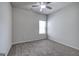 An empty bedroom with neutral carpet, ceiling fan, and a window letting in natural light at 158 Bryon Ln, Acworth, GA 30102