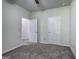 A view of the bedroom, showcasing the neutral walls, carpet, and multiple doorways at 158 Bryon Ln, Acworth, GA 30102