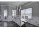 Bright dining room featuring modern lighting, a glass table and white chairs at 158 Bryon Ln, Acworth, GA 30102