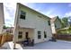 A view of the exterior back of the home with a covered patio and fenced yard at 158 Bryon Ln, Acworth, GA 30102