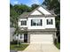 Charming two-story home with white siding, black shutters, and a stone-accented garage at 158 Bryon Ln, Acworth, GA 30102