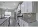Modern kitchen with white cabinetry, stainless steel appliances, and granite countertops at 158 Bryon Ln, Acworth, GA 30102
